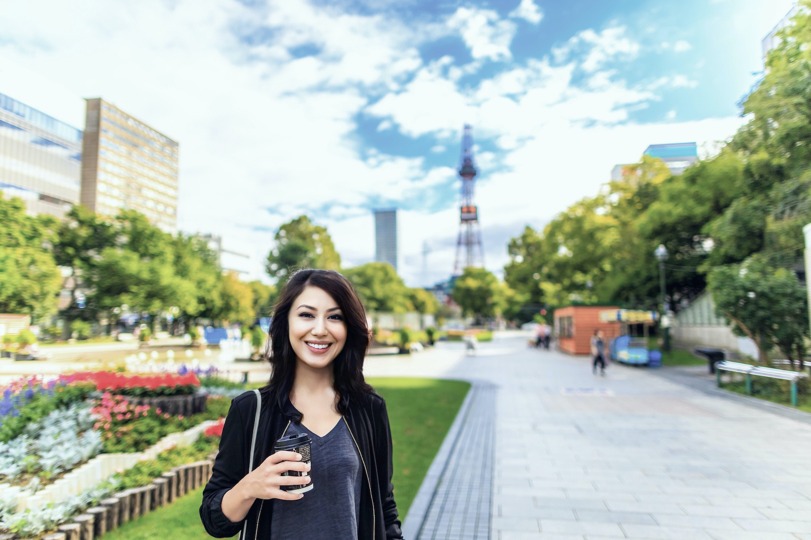 Adobe Stock 120557042 Young Asian woman enjoying Odori Park, Sapporo, Hokkaido, Japan